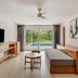 Fiesta Americana Cozumel suite with pool view, sofa bed, TV, and sliding glass doors to balcony