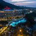 Kaya Izmir Thermal & Convention in Izmir with illuminated outdoor pools at dusk and city views