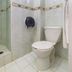 Capital O Hotel Suites Marne, Mexico City bathroom with glass shower enclosure and toilet