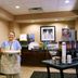 Hampton Inn Maysville breakfast area with staff member holding a plate and coffee station