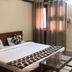 Goroomgo Mourya Inn Madhya Pradesh in Harda, guest room with double bed, glass table and wall mirror