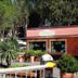 Tigullio Camping & Resort in Sestri Levante, small reception building with trees and potted plants