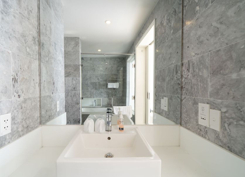 Star City Riverside Hotel By Haviland in Da Nang: modern bathroom vanity with sink and large mirror