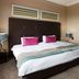 Apollo Hotel Johannesburg guest room with king bed, mirrored wardrobe and bedside lamps