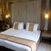 Royal Capital Thermal & Spa Hotel in Bursa guest room with twin beds, wood-paneled walls and bedside lamps