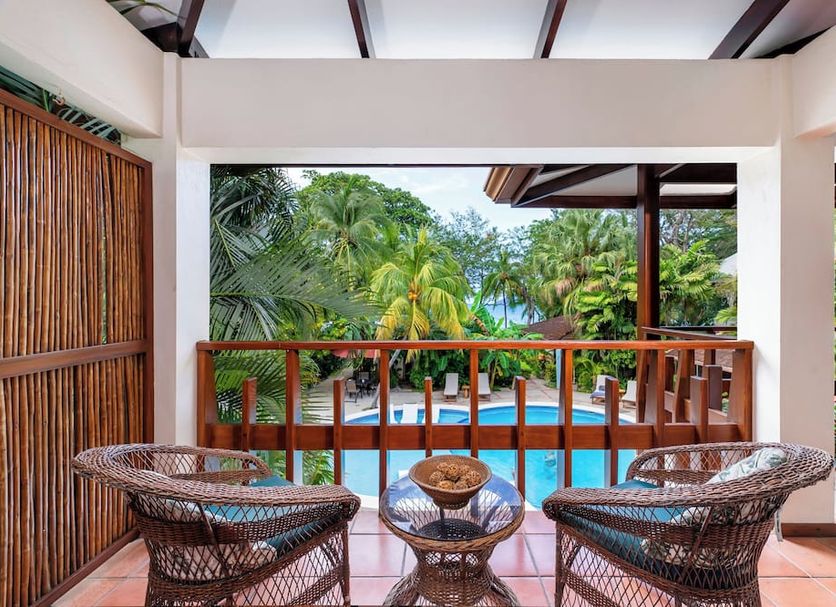 The Coast Beachfront Hotel in Tamarindo balcony view of pool and tropical palms