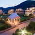 Bhanwar Singh Palace, Pushkar: illuminated resort gardens, pavilion, and mountain backdrop at dusk