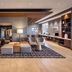 Hyatt Place South Reno lobby with seating area, floor lamp, and built-in shelving in Reno