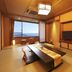 Houraiya in Kamogawa tatami room with low table, TV, and ocean view through window
