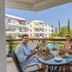 Artemis Cynthia Complex Paphos balcony dining with family and pool view