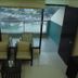 Ganga Beach Resort in Rishikesh with balcony view of the river and hills, plus two chairs inside