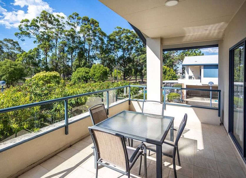 Hawkesbury Race Club Motel in Windsor balcony with table, chairs and tree-lined view