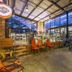 Sunrock Guesthouse in Kempton Park interior with glass walls, orange chairs, and parked bicycles