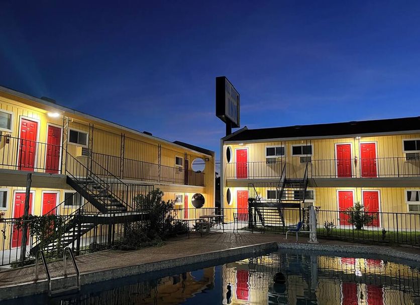 Ladybird Inn in Johnson City with courtyard pool and exterior stairways at dusk
