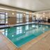 Comfort Suites Broomfield-Boulder/Interlocken indoor pool with large windows and lounge area in Broomfield