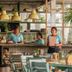 Hotel Barahona Cartagena dining area with turquoise tables, hanging lamps, and staff at the counter