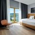 mk hotel tirana in Tirana guest room with double bed, balcony view, and modern seating
