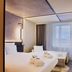 Novotel Zurich Airport Messe room in Zurich with two beds, window view, and modern lighting