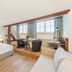 Tailormade Hotel Rüden Schaffhausen guest room with bed, seating area, desk and large windows