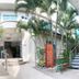 Hotel Mar Azul in Manta courtyard with palm trees, stairway, and glass entrance