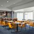 Courtyard by Marriott Dallas-Fort Worth/Bedford lobby lounge with tables, bar seating and large windows