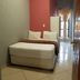 Central Lodge Hotels in Johannesburg room with single bed, tiled floor, and window with curtains