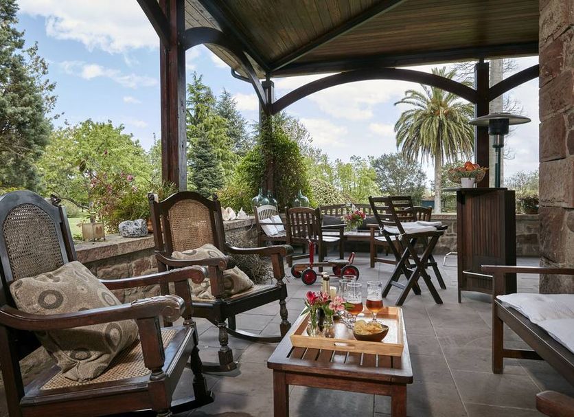 Jardin de Carrejo in Cabezón de la Sal, outdoor terrace with armchairs, tables and garden views