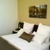 C Hotel Tiberias in Tiberias guest room with neatly made bed and wall art