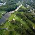 Blue Rock Resort in South Yarmouth with aerial view of golf greens, ponds, and wooded grounds
