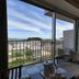 Ocean Resort Pmc in Onna, room with balcony view of the sea and nearby buildings