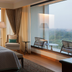 The Oberoi New Delhi room with floor-to-ceiling windows and city views in New Delhi
