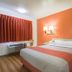 Motel 6 Lakewood, Co - Denver guest room with bed, orange accent wall, window and air conditioner