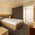 Caravelle Hotel Im Park Bad Kreuznach guest room with double bed, seating area and patterned carpet