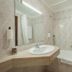 Estalagem Vianorte bathroom in Matosinhos with marble walls, bathtub, sink and shower curtain