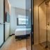 Leonardo Hotel San Sebastián bathroom with glass shower and sink, leading to a bedroom with window view in San Sebastian