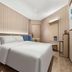 Hanting Harbin Convention and Exhibition Center Hengshan Road Branch guest room with bed and minimalist wood paneling