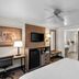 Baymont by Wyndham Arlington At Six Flags Dr guest room with TV, mini fridge, desk and vanity in Arlington