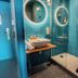 greet hotel Montpellier Aéroport Parc des Expos bathroom with blue tile, sink and walk-in shower in Mauguio