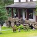 Rock Castle Resort in Lake George with stone patio, lawn seating, and trees