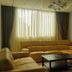 Appart Hotel Mouna Marrakech living room with sofas, coffee table and window curtains