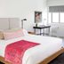 Bluebird Spa City Motor Lodge room in Saratoga Springs with bed, desk, and window bench