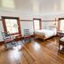 Shaker Village of Pleasant Hill in Harrodsburg, bedroom with two wooden beds and polished hardwood floors