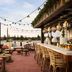 Graduate by Hilton Palo Alto rooftop terrace with string lights, bar seating and lounge chairs