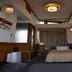 Business Hotel Crescent Tokyo guest room with bed, desk, TV, and curtained window