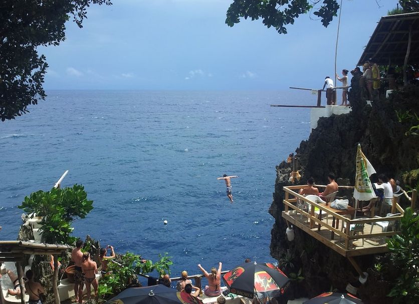 Villa Sunset Boracay in Boracay with cliffside terrace, ocean view, and people jumping into the sea
