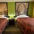 Super 8 by Wyndham Jacksonville guest room with two double beds and city skyline wall art