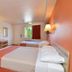 Motel 6 Twentynine Palms guest room with two beds, desk, TV, and window