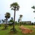 Breeze Hill Resort in Khao Kho with palm trees, grassy grounds, and a hillside building