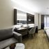 Aprilis Deluxe Hotel Istanbul guest room with two beds, desk, sofa and city-view curtains