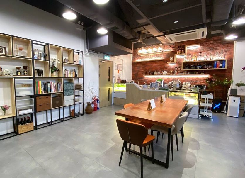 Starphire Hotel in Hong Kong lounge with wooden table, open shelving, bar counter and modern seating